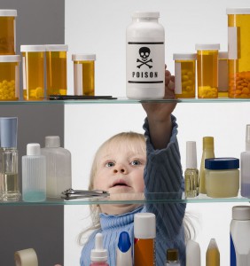 child reaching in medicine cabinet