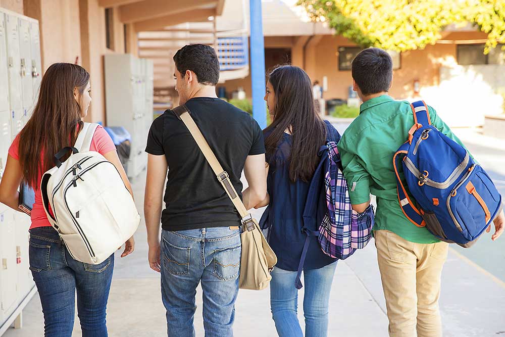 Group of four teenagers from back